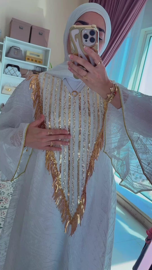 White dress with gold tassels